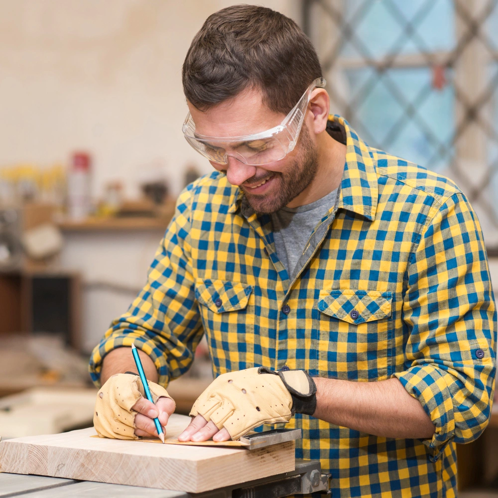 Male carpenter in plaid shirt measuring wood in Dallas workshop