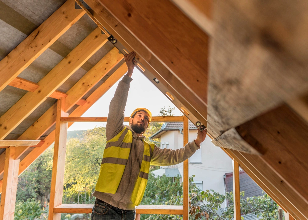 Construction worker measuring roof frame during custom woodwork project in Dallas